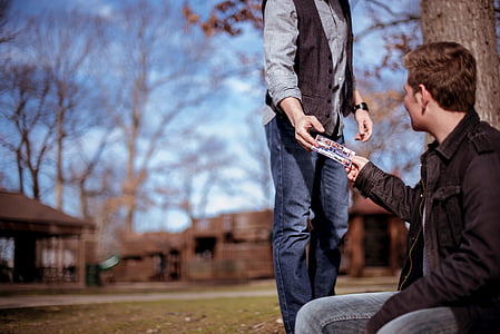 two men near trees and houses thumbnail