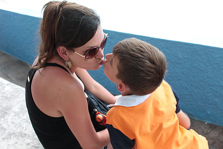 woman kissing child thumbnail