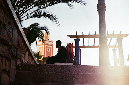 man sitting on bench during daytime thumbnail