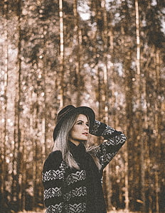 woman standing near trees during daytime thumbnail