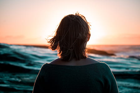 woman facing in front of body of water thumbnail