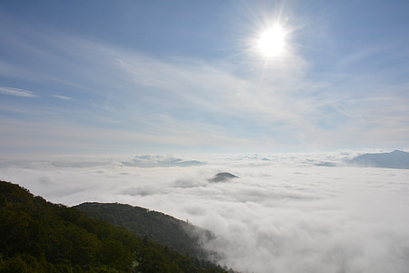 brown mountains covered with smoke at daytime thumbnail