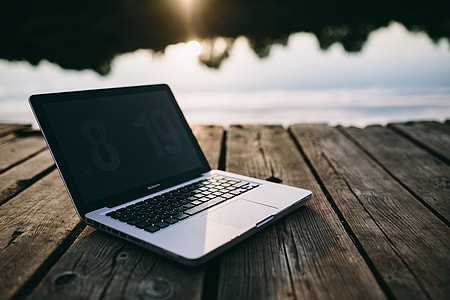 Man working on Macbook at lake thumbnail