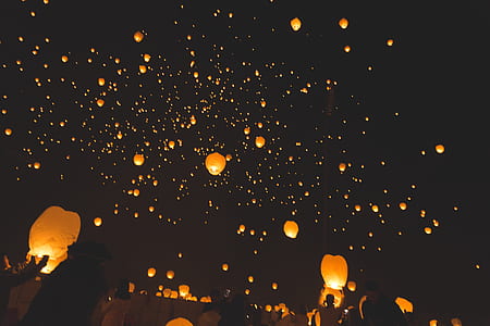 sky lanterns floating on air at nighttime thumbnail