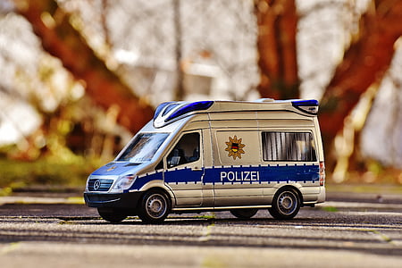 close-up photography of white and blue police van die-cast model thumbnail