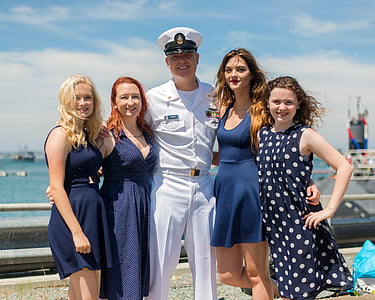 five people taking photo near cruise ships thumbnail