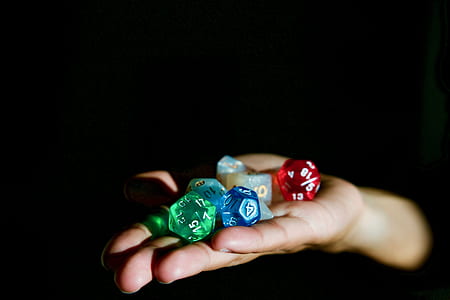 person holding assorted-color playing dies thumbnail