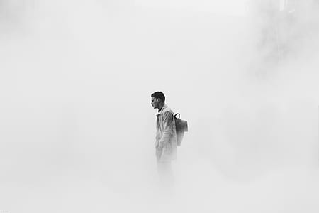 grayscale photo of man surrounded with mist thumbnail