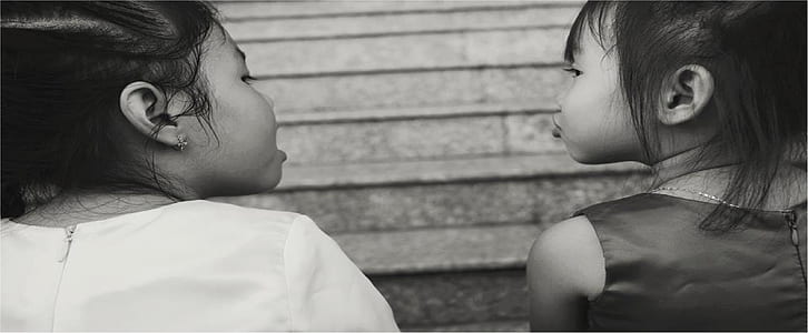 grayscale photo of two girls thumbnail