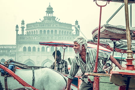 man holding red and white carriage thumbnail