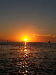 boats on ocean during golden hour thumbnail