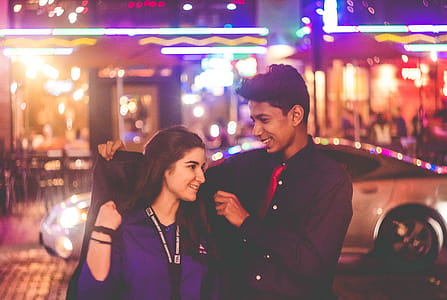 Man Giving Jacket to Woman thumbnail