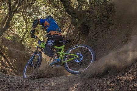 man riding green full-suspension bicycle thumbnail
