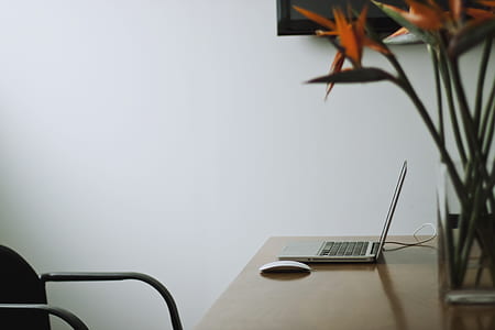 black and silver laptop computer with cordless mouse on office desk thumbnail