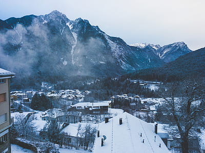 Snow Covered House Near Snow Covered Mountain Under Clear Sky thumbnail