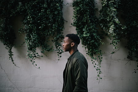 man wearing black leather jacket during daytime thumbnail