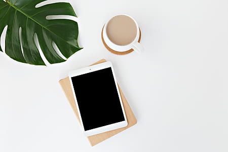 white iPad on top of white surface thumbnail