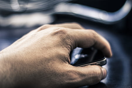 person holding black smartphone thumbnail