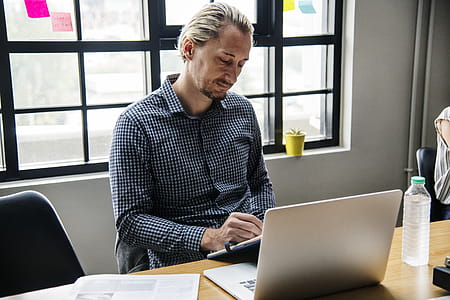 Man Sitting Beside Clear Glass Window thumbnail