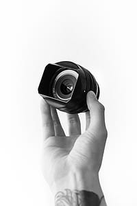 selective color photography of person holding camera zoom lens thumbnail