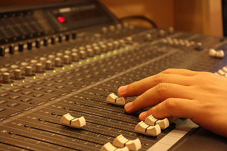 person holding white audio mixer button thumbnail