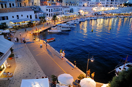 yachts beside dock during nighttime thumbnail
