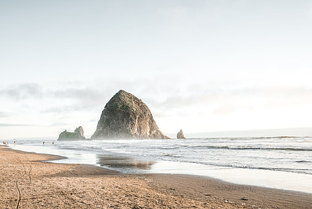 rock formation in body of water during daytime thumbnail