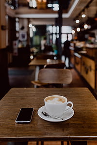 Cup of coffee on table in cafe thumbnail