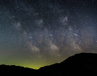 landscape photography of mountain silhouette and Milky Way galaxy during nighttime thumbnail
