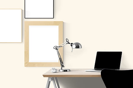 stainless steel desk lamp beside MacBook Pro thumbnail