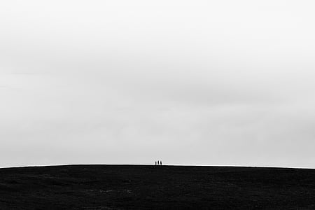 silhouette of three people under gray sky during daytime thumbnail