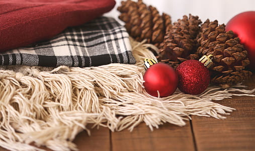 Two Red Baubles Beside Pine Cones thumbnail