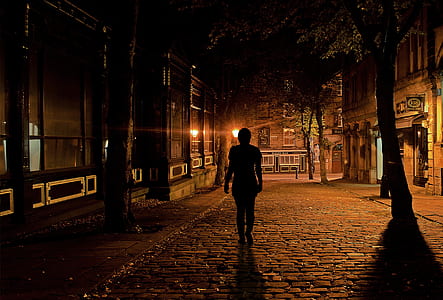 silhouette of woman standing besides building thumbnail
