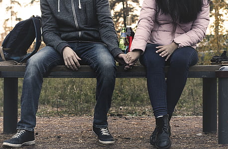 person holding their hand each other on bench thumbnail