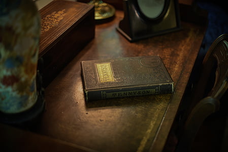 black covered book on table thumbnail