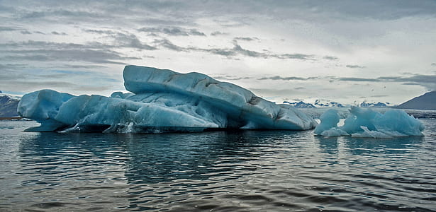 floating ice bergs on body of water thumbnail