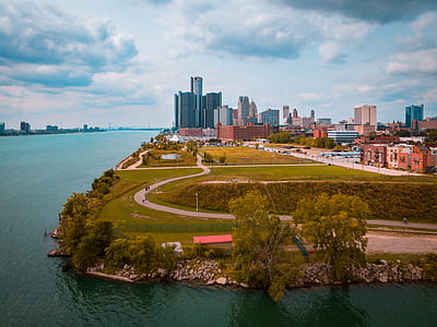 bird's eye photography of green field with buildings thumbnail