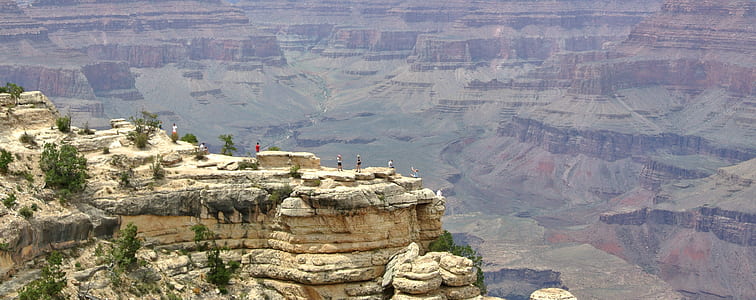people on rock formation during daytime thumbnail