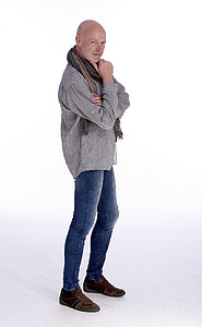 man wearing gray jacket and blue denim jeans standing thumbnail
