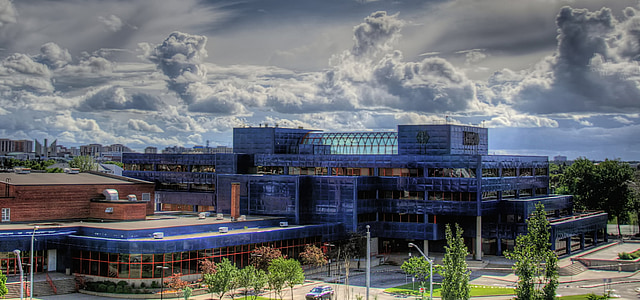 blue and brown concrete building under cloudy sky during daytime thumbnail