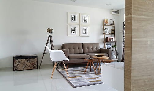 brown 2-seat sofa near white plastic chair thumbnail