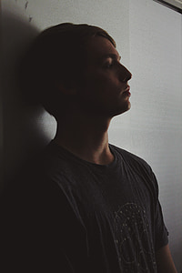 man leaning in white wall thumbnail