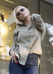 woman wearing gray dress shirt and blue denim bottoms thumbnail