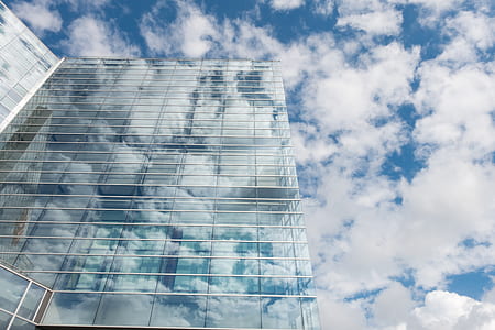 Bottom View of Clear Glass Building Under Blue Cloudy Sky during Day Time thumbnail