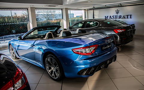 blue Maserati convertible coupe parked inside building thumbnail