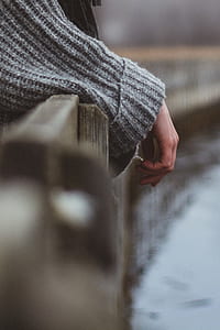 selective focus photography of person wearing grey sweater thumbnail