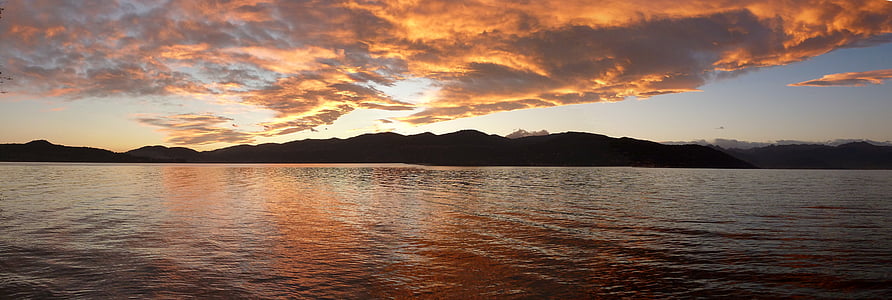 mountain near body of water at golden hour thumbnail
