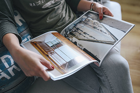 Woman reading a designer magazine on a couch thumbnail