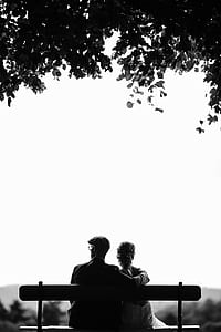 man and woman sitting on bench thumbnail