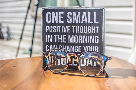 Photo of a Sign and Eyeglasses on Table thumbnail